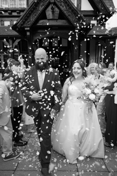 Bride and groom confetti exit outside Worsley Court House, Manchester Wedding