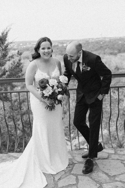 Black and white photo of a couple laughing during their portraits at Chapel Dulcinea