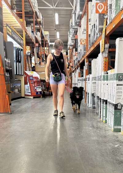 Dog trainer teaching dog not to pull on leash near Charleston SC. This is during a doggy daycare and training session.