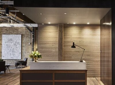 reception desk in a boutique hotel with raw concretefinished concrete giving the look of aged stone.