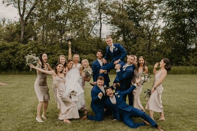 A newlywed couple on their wedding day get launched in their air by their closest friends who joined them in the wedding party.