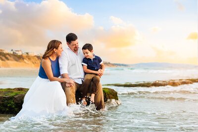 Portrait of a family playing in the ocean in San Diego