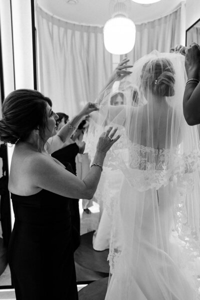 Mother of the bride adjusting her daughter’s veil before the ceremony at Altos de Chavon — emotional black and white wedding moment by Asia Pimentel Photography.