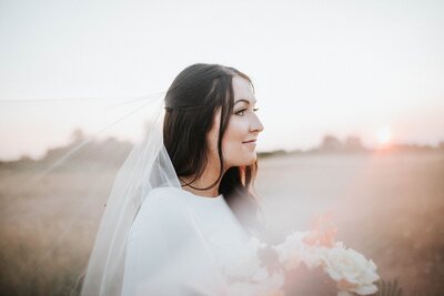 bride looking out to the nashville landscape in her beautiful dress and veil