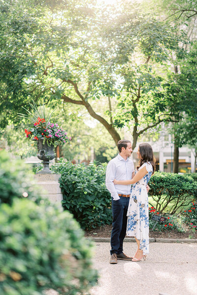 Couple embracing at their engagement session at Rittenhouse Square in Philadelphia, PA