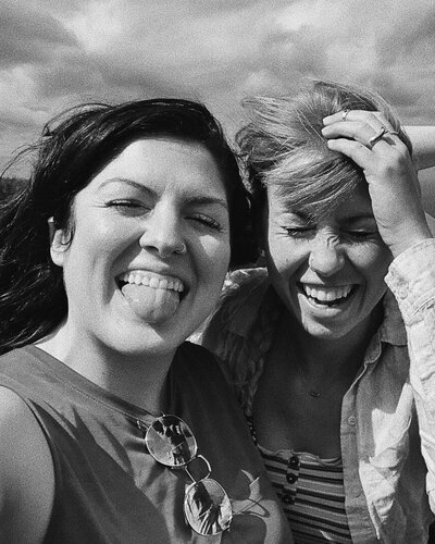 two young girls in photo booth with glasses of wine