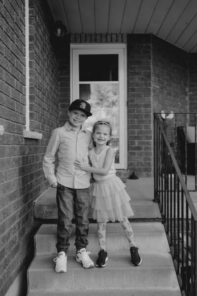 black and white photo of young boy and girl