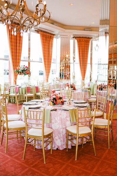 A wedding photo of the reception room that is pink themed