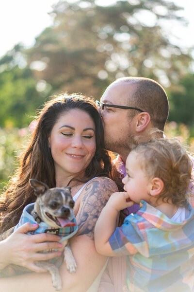 The Shaw family  cuddles close for a family portrait at  the Columbus Park of Roses.