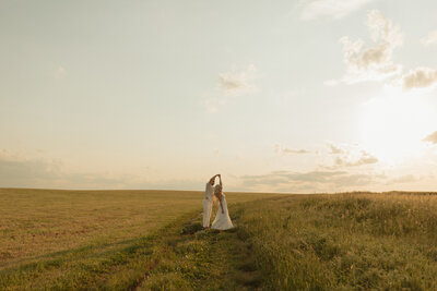 couple dancing in field for lifestyle photos in prince edward island