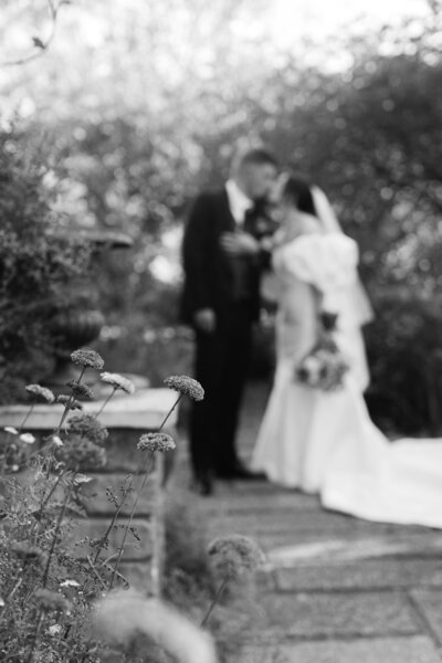 Bride and groom kissing in botanical gardens