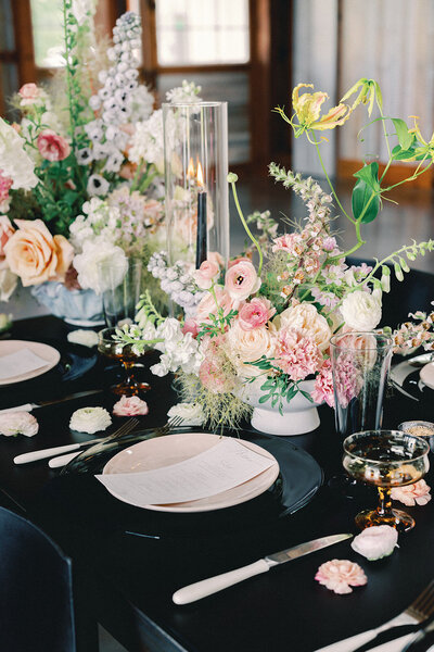 Table setting with large pink and white floral centerpieces