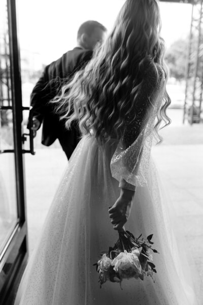 Bride walking out with her groom, smiling and celebrating as they begin their life together in Columbus, Ohio.