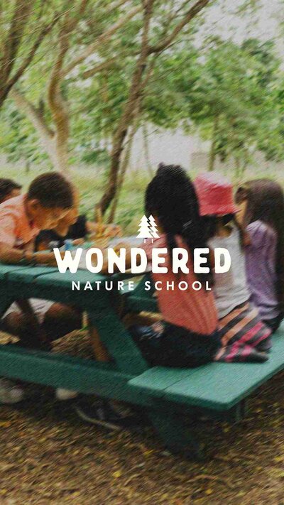 Wondered nature school branding with kids at a picnic table, showcasing earthy tones and nature-inspired design.