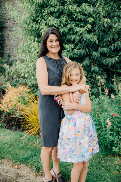 mother-and-daughter-in-dresses-posing-for-photograph