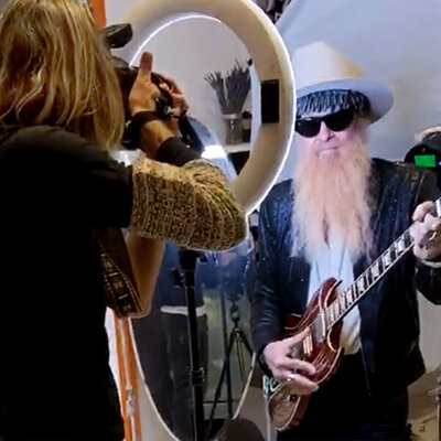 Billy F Gibbons Portrait Behind the Scenes The Art of Giving Mark shooting photo through ring light while Billy holds his guitar