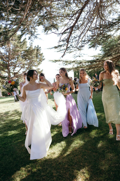 Wedding Photography, bride  and her bridal party walking with their bouquets