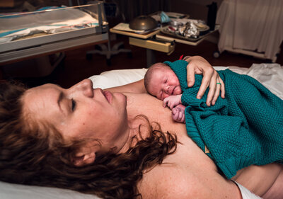 Mom holding newborn after birth
