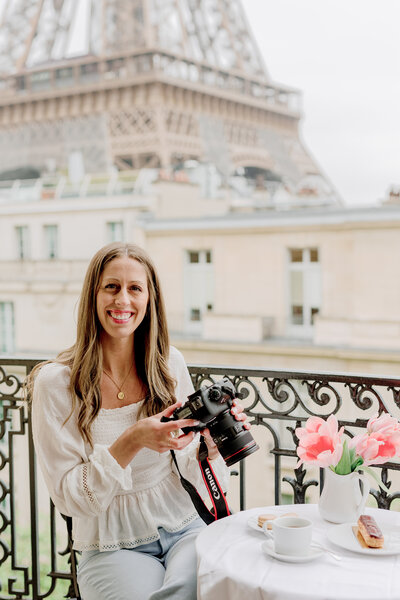 Danielle smiling while holding her camera