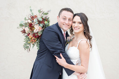 bride and groom smile cheek to cheek