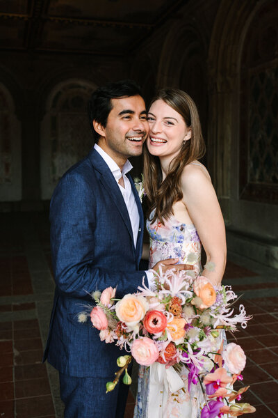 NYC central park elopement couple laughing at bethesda terrace with floral zimmerman dress