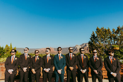 groomsmen standing in sun with sunglasses at agave of sedona wedding venue
