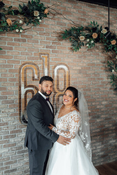 618 Restaurant | Bride and groom posing by ivy-covered wall during wedding photo | Freehold, New Jersey