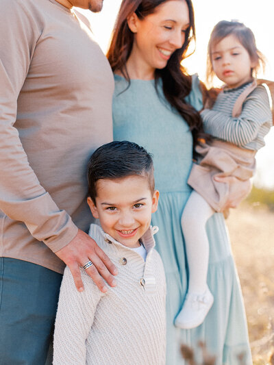 little boy smiling with his family Cynthia Knapp Photography family photographer