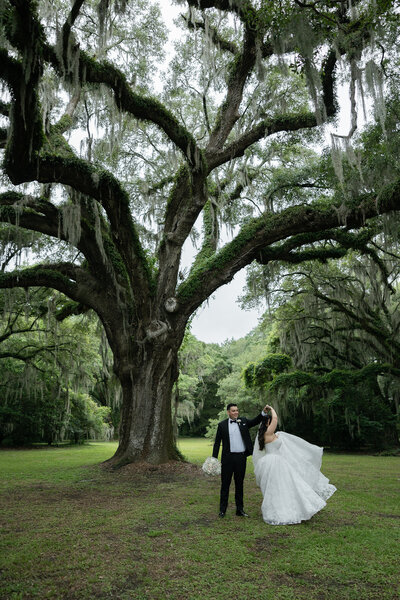 bride and groom photos of bride standing in front and groom hugging from behind