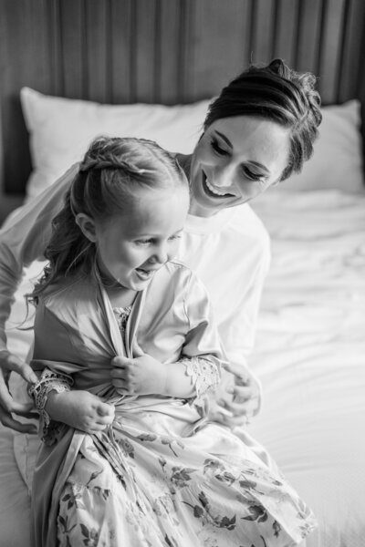 A sweet moment with a bride and her flower girl in black and white by Florida wedding photographer Angelika Krug Photo & Film