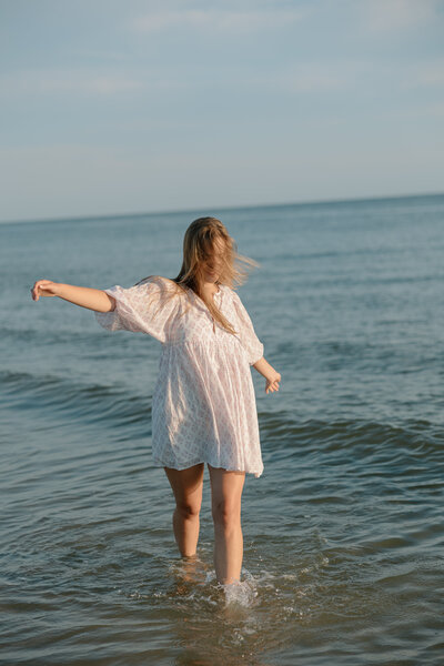 Senior walks around and plays in the ocean