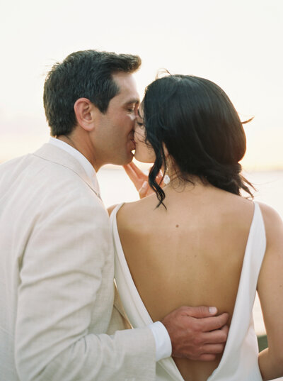 A portrait of a bride and groom kissing at their wedding in Boothbay Harbor, Maine