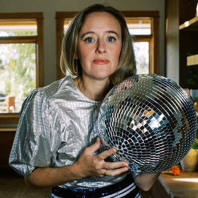 photo of a woman holding a disco ball