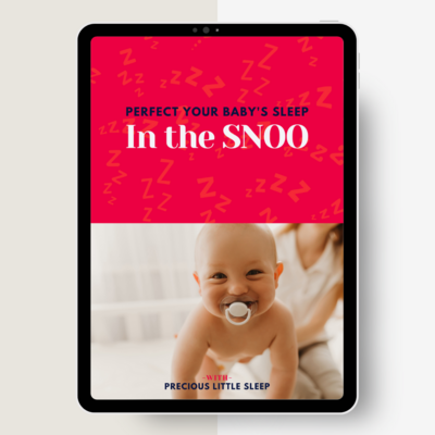 woman sitting on a couch looking at an ipad
