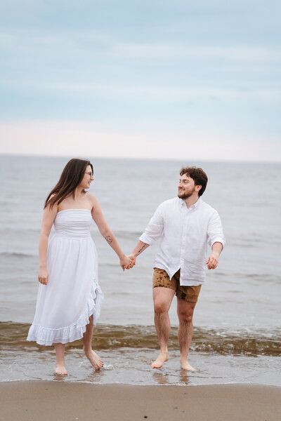 rockport, MA engagement photos with couple going into water 