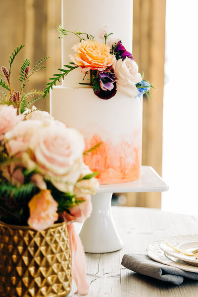 Wedding detail photo of cake and flowers at Fox Fields venue in Red Lodge, MT