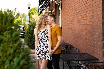 man and woman smiling at each other while holding hands