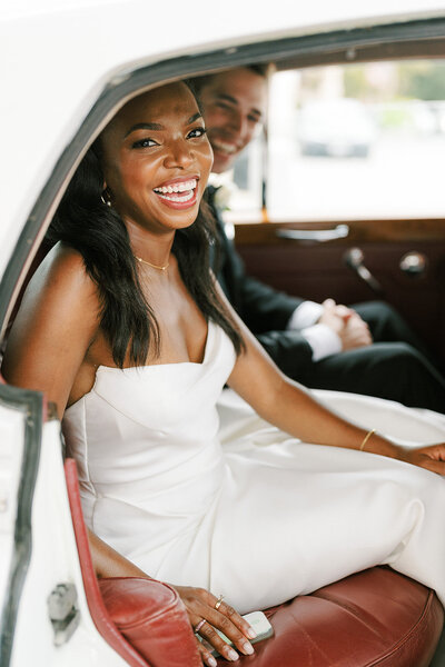 laughing happy bride in vintage car limo wedding baltimore