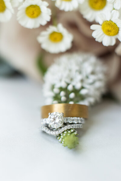 Wedding rings on flower of bouquet at Hawkesdene Andrews NC wedding