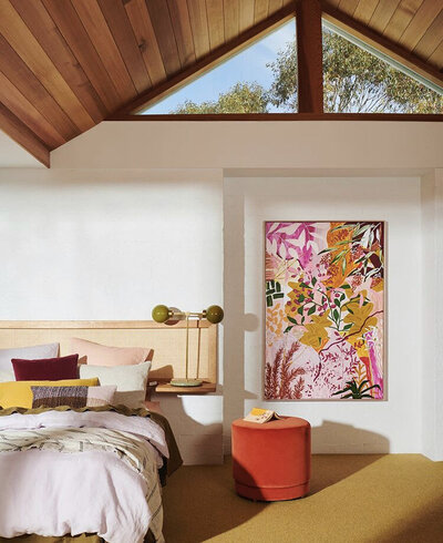 Mid-century inspired bedroom with pitched timber ceiling and vibrant artwork styled by Hunter Interiors in Melbourne.
