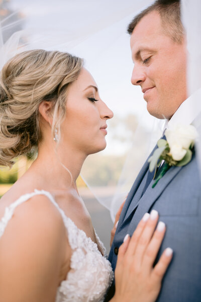 Bride and groom kiss waterfront