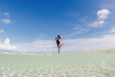 couple dancing on sandbar with a lift