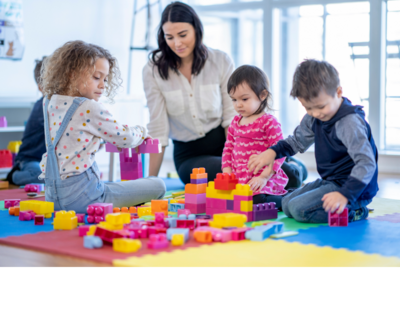 Teacher playing with children in daycare classroom in Yarmouth, NS

