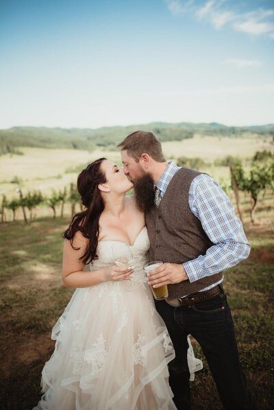 Romance writer TJ Deal kissing her husband on wedding day.
