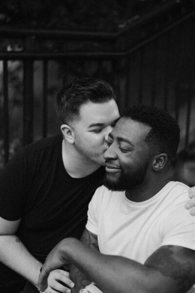 Micah and Doug laughing during their Richmond engagement session, photographed in a relaxed, documentary-inspired style.