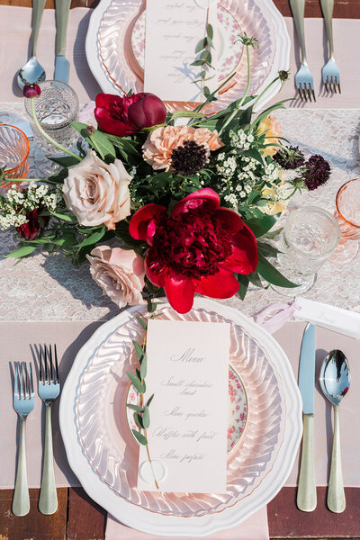 Classic, romantic, red and pink wedding reception table scape designed by Melissa Dawn Event Designs, wedding planner in Calgary, Alberta, featured on the Brontë Bride Vendor Guide.