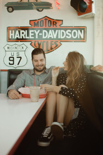 Couple eating fries and shakes at vintage diner in Eastern Washington.