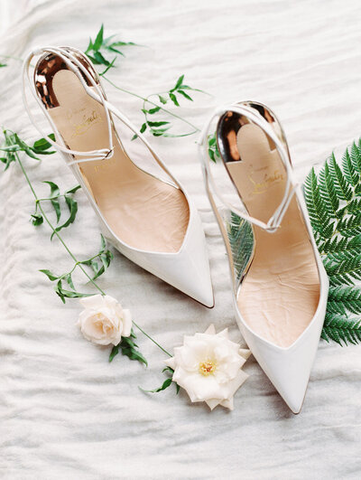 Louboutin Wedding Shoes styled in a flat lay with roses and fern Arizona Wedding Photography
