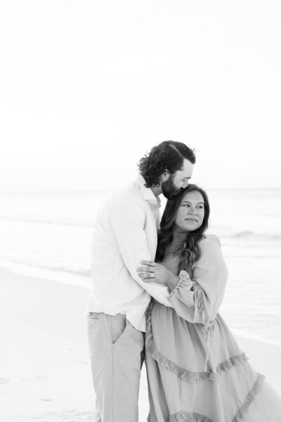 man kissing wife on the head at the beach — Madison Abernathy Photo
