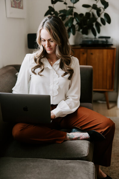 A website copywriter working on a laptop